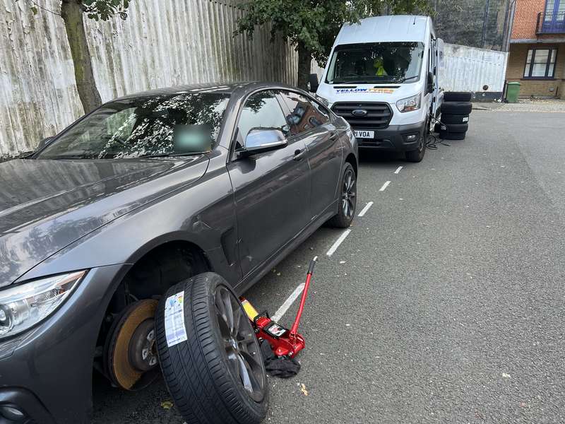 A new labelled tyre going onto a grey BMW Gran Coupé, our van behind – Yellow Tyres mobile tyre repair service, covering Whitechapel