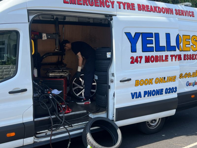 Our fitter using the tyre machine inside the van – Yellow Tyres genuine, traceable new tyres