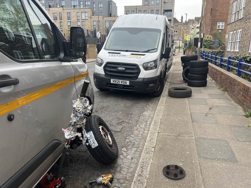 A customer’s van with a wheel off at the kerbside, our van and tyres further down the street – a real Yellow Tyres job, from our Essex borders page