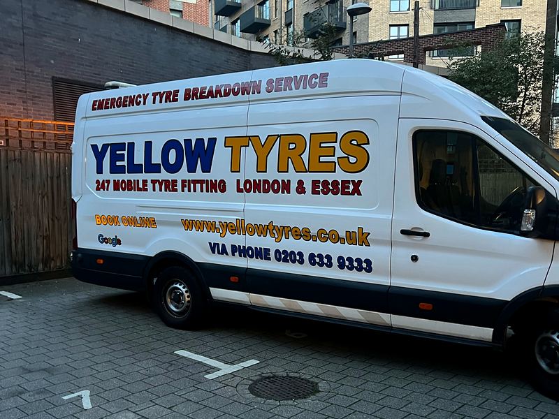 White Yellow Tyres van showing '247 Mobile Tyre Fitting London & Essex' and phone number, parked in a residential courtyard